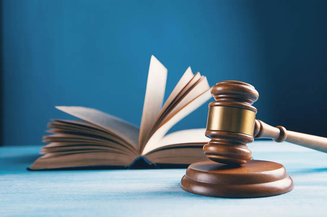Judge's gavel and open law book - law office Judge's gavel and open law book - law office